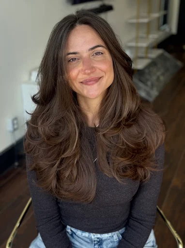 Long layered brunette blowout with soft waves